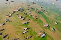 CAMBODIA, Siem Reap. Chong Kneas floating village, Tonle Sap lake. Aerial view from ultralight aircraft.