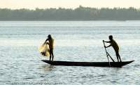 CAMBODIA, Stung Treng. Fishermen in canoe on Mekong River.