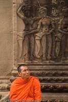 CAMBODIA, Siem Reap, Temples of Angkor. Buddhist monk and Aspara (heavenly nymphs), Angkor Wat temple complex.