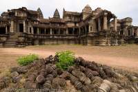 CAMBODIA, Siem Reap, Temples of Angkor. Eastern aspect of Angkor Wat temple complex, with a pile of broken stone balusters.