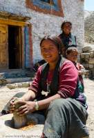 NEPAL, Dolpo. Woman grinding pepper at Samling (Shyamling) Gompa, a Bon monastery.