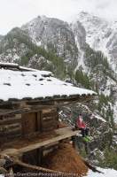 INDIA, Uttaranchal, Govind National Park. Trekker/skier at seasonal-use hut, Rupin valley.