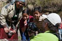 INDIA, Uttaranchal Govind National Park, Jikson. Curious local woman and children looking at digital photo.
