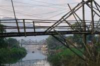 LAOS, Vientiane, Vang Vieng. Rickety bridge over channel of Nam Song river.