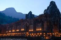 LAOS, Champasak. Ruined pavilions of middle level of Wat Phu, ancient Khmer religious complex, built between 10th & 16th centuries, lit by candle lanterns.