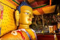 Head of 7.5m tall gilded-copper Buddha statue within Naropa Palace temple, originally installed in 1645.