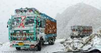 Decorated freight trucks crossing Khardung La (5602m, claimed to be the highest motorable pass on Earth) in fresh snow.