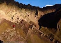 Uplifted and folded sedimentary rock strata below Namlung La (4900m), Hemis National Park. Sunset.