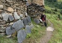 Woman and mani wall, Tsum Valley, Manaslu Circuit trek, Nepal