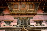 NEPAL. Carved wooden windows above entrance to Mul Chowk, Royal Palace, Durbar Square, Patan. Built in 17th century. Part of World Heritage-listed monument zone of Kathmandu Valley.