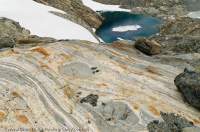 NORWAY, Troms, Lyngsalpan (Lyngen Alps). MIneral banding in gneiss bedrock beside Strupbreen glacier.