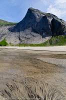 NORWAY, Nordland. Lofoten Islands, Moskenesoy. Sand patterns in stream, Bunes beach.