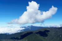 Morning cloud building over West Papua section of Star Mountains, from Mt Capella, Papua New Guinea.