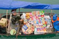 VIETNAM, Northeast, Halong Bay. Boat-borne drink and biscuit vendors frequent popular tourist anchorages.