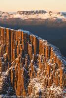 Columnar dolerite cliffs of the Acropolis, in Du Cane Range, loom before Mt Olympus, winter. Cradle Mountain - Lake St Clair National Park, Tasmanian Wilderness World Heritage Area.