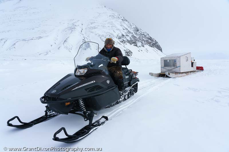 image of Inuit on snowmobile