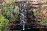 AUSTRALIA, Western Australia, West Kimberley. Waterfall cascades over sandstone strata, Bachsten Creek.
