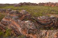 AUSTRALIA, Western Australia, East Kimberley, Purnululu National Park (Bungle Bungles).  Layered sandstone domes beside Piccanniny Creek, sunrise.