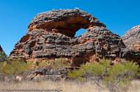 AUSTRALIA, Western Australia, East Kimberley, Purnululu National Park (Bungle Bungles). Layered sandstone dome with eroded arch.