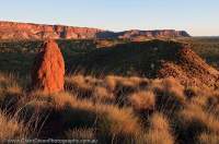 AUSTRALIA, Western Australia, East Kimberley, Purnululu National Park (Bungle Bungles). Termite mound & sunset on western escarpment of Bungle Bungle Range.