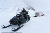 Inuit man on snowmobile, Eclipse Sound sea ice, Bylot Island, Nunavut, Canada