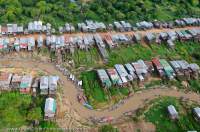 CAMBODIA, Siem Reap. Kompong Phluk village, with houses on stilts due to seasonal flooding of nearby Tonle Sap lake.  Aerial view from ultralight aircraft.