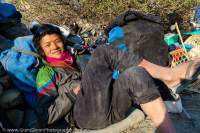 NEPAL, Dolpo. Expedition porter resting at day's end.