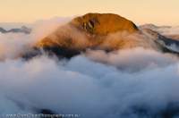 NEW ZEALAND, Fiordland National Park. Dawn cloud, Heath Mountains.