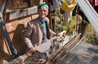 INDIA, Uttaranchal Govind National Park, Jikson. Old man with loom, weaving woollen cloth used for clothes similar to the jacket he is wearing.