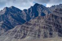 Uplifted and folded sedimentary rock strata in Stok Range, above Indus valley.