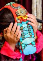 Woman in traditonal costume, with turquoise-decorated headgear, Ladakh Festival, Leh, 2013