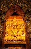 Mahamuni Paya gold Buddha. Knobby appearance of the statue body is due to centuries' of application of gold leaf by male devotees.