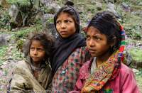 NEPAL, Mugu. Three sisters, curious at trekkers' campsite.