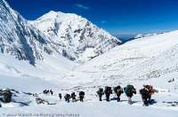 NEPAL, Mugu. Porters ascending to Chyarga La pass (5150m) through fresh snow.