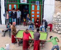 NEPAL. Young boys and monks placing pool in street, Mustang.
