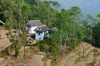 NEPAL. Grass-roofed house & terraced fields, lower Arun valley, Makalu Base Camp Trek.