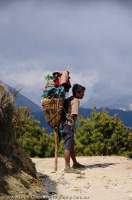 NEPAL. Sagamartha National Park. Porter rests his load on T-stick, carried for the purpose, Dudh Kosi gorge, Everest Basecamp trek.