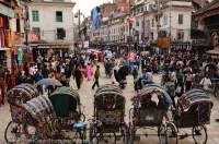 NEPAL, Kathmandu. Cycle-rickshaws & crowded street, Chetrapati Chowk.