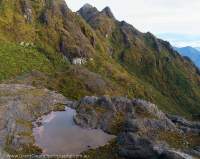 Tarn in glacial cirque below Mt Scorpio, Star Mountains, Papua New Guinea.